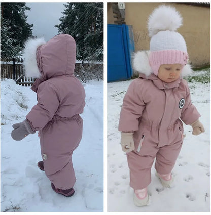 Infant in a cute unisex winter jumpsuit, warm outerwear for cold weather adventure
