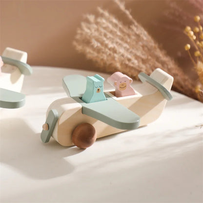 Close-up of a child's hands grasping the wooden Montessori airplane, enhancing motor skills
