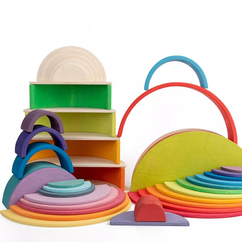 Vibrantly painted wooden rainbow stacker discs arranged in an arch, an engaging educational toy.