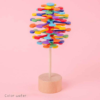 Wooden spinning lollipop toy displayed as a desk decor item, offering visual appeal and stress relief.