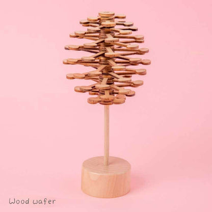 Person holding a wooden spinning lollipop toy, showcasing its portability and stress-relieving function.