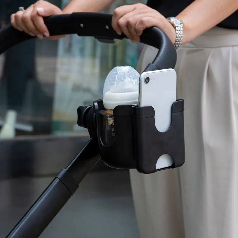 Universal stroller cup holder securely grips baby bottles or drinks, black adjustable design.