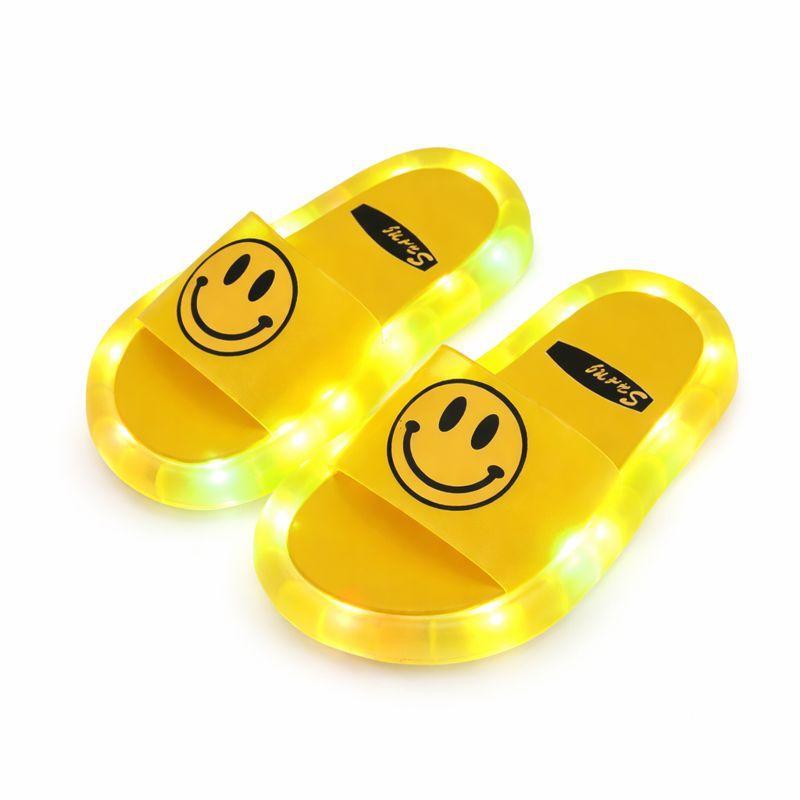 Pair of green light-up kids' beach slippers, non-slip soles for active summer play