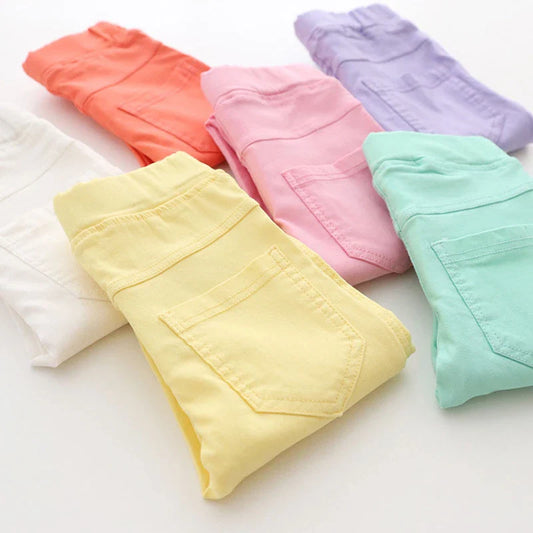 Vibrant candy-colored girls' pencil pants with comfortable elastic waist, perfect for kids' fashion.