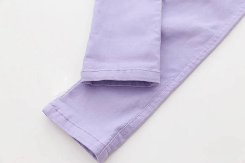 Playful candy-colored girls' pencil pants with elastic waist, perfect for vibrant child clothing.