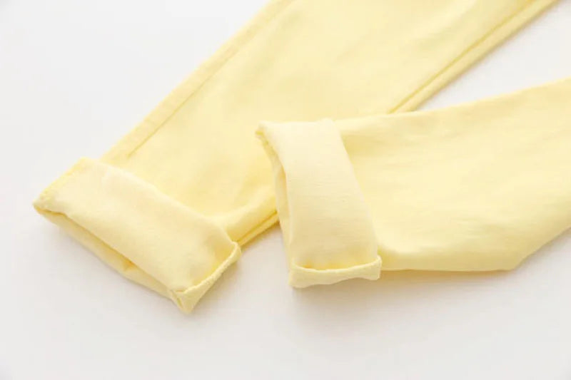 Close-up of elastic waist detail on vibrant candy-colored girls' pencil pants.