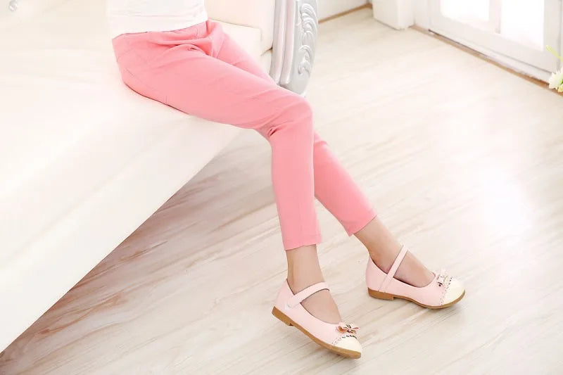 Girls' casual fashion: bright candy-colored pencil pants with a practical elastic waist.