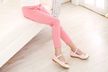 Girls' casual fashion: bright candy-colored pencil pants with a practical elastic waist.