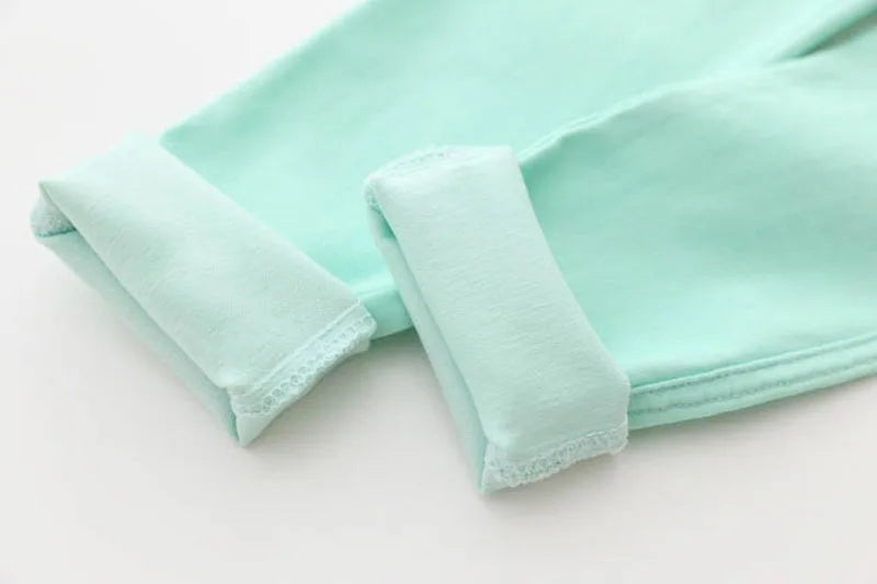 Adorable candy-colored girls' pencil pants with a soft elastic waist, ideal for comfortable kidswear.