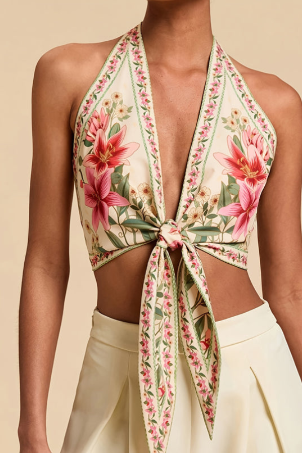 Women's vibrant floral halter top styled casually with shorts for a summer look.