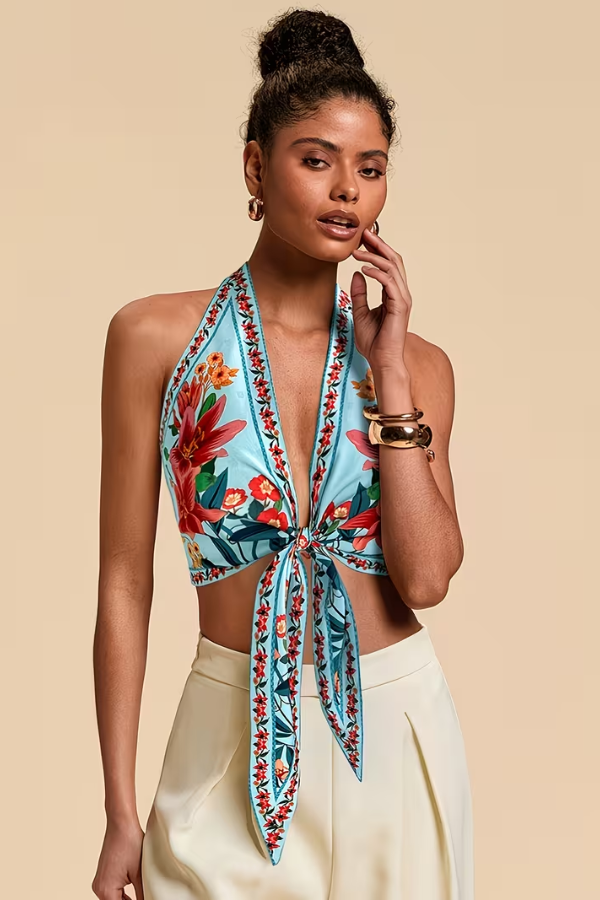Tropical-inspired women's vibrant floral halter top for sunny beach and resort wear.