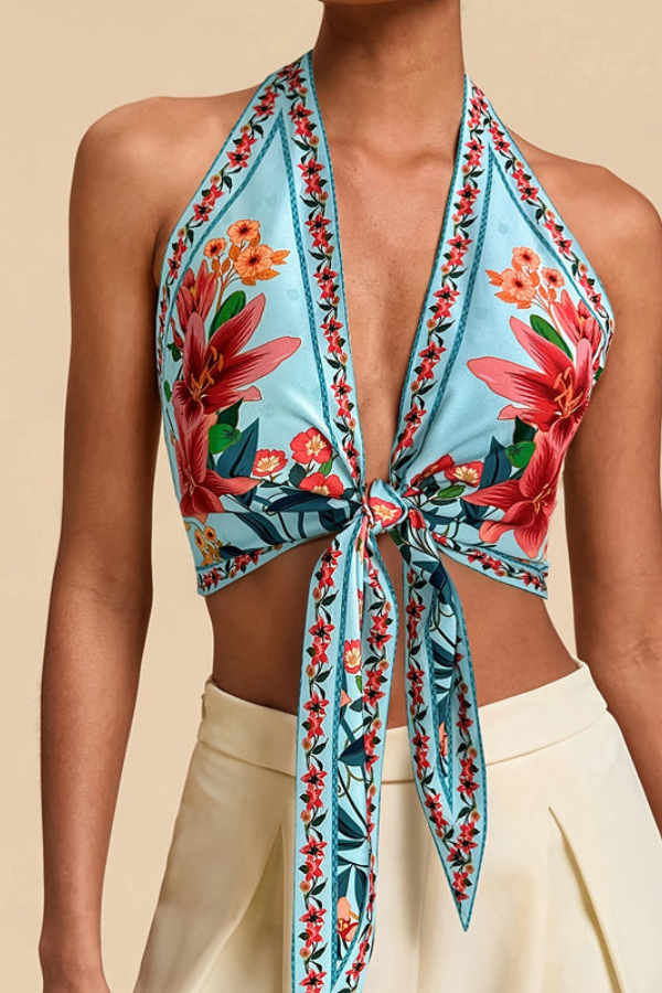 Women's fashion: vibrant floral halter top, a versatile piece for casual summer events.