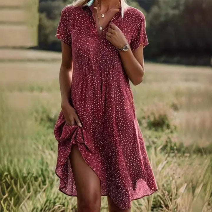Chic women's short floral midi dress, vibrant design, comfortable & flowy, suitable for casual wear or parties.