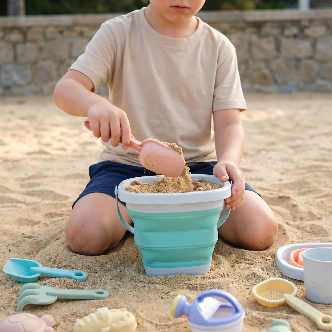 Vibrant kids' collapsible beach toy set with bucket, shovel, and sand molds, perfect for travel & easy storage.