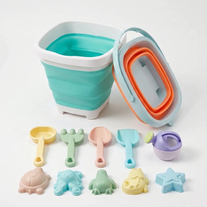 Portable kids' collapsible beach toy kit including bucket, rake, shovel, and various sand molds for easy travel.