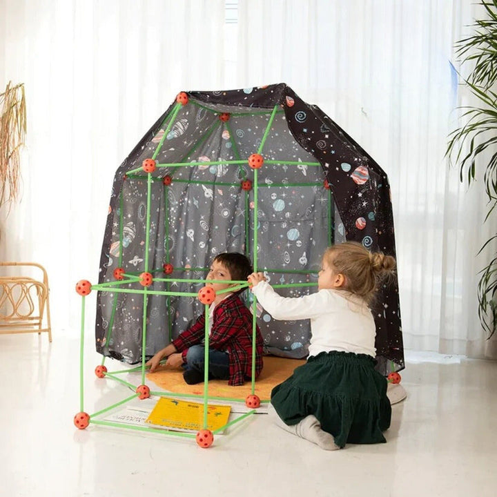 Child happily playing inside a self-built fort, a fun indoor construction toy & educational gift.