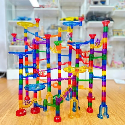 Dynamic action shot of marbles racing through a multi-level kids' educational building set