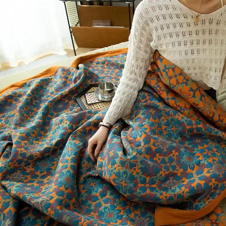 Luxurious six-layer cotton quilt in vibrant orange & blue. Warm & comfortable bedding, perfect for a cozy bedroom.