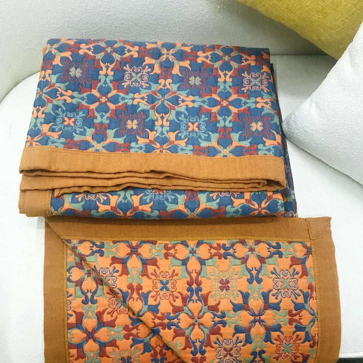 Eco-friendly six-layer cotton quilt with a vibrant orange & blue pattern. Warm, comfortable bedding for modern homes.