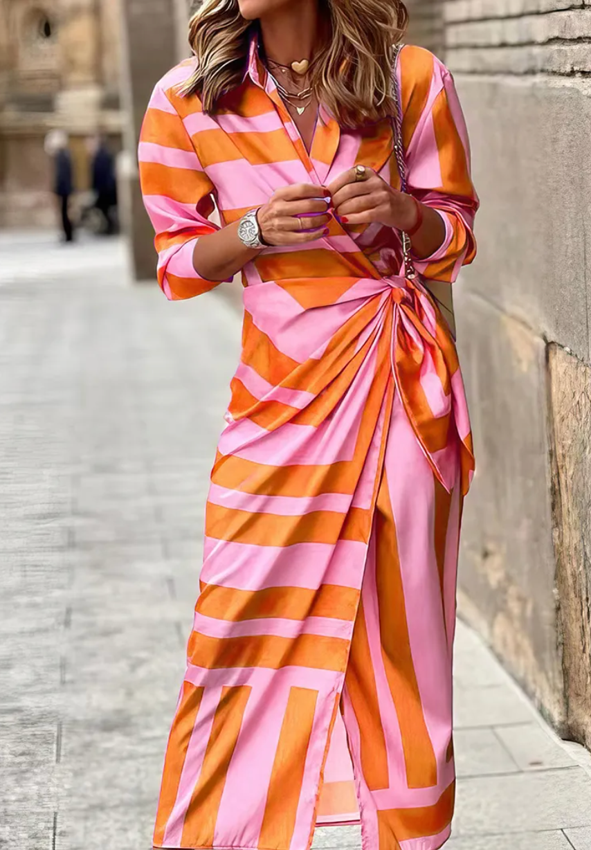 Women's vibrant printed wrap dress with collared neckline. Effortless fashion for summer events.