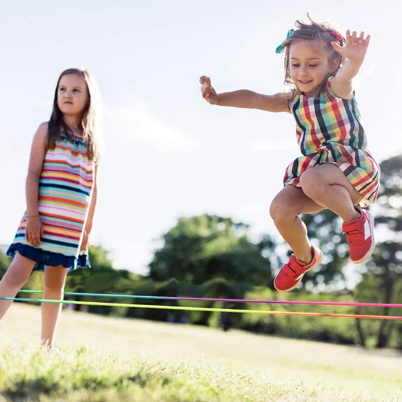 Close-up of a children's rainbow jump rope with comfortable handles, ideal for playtime