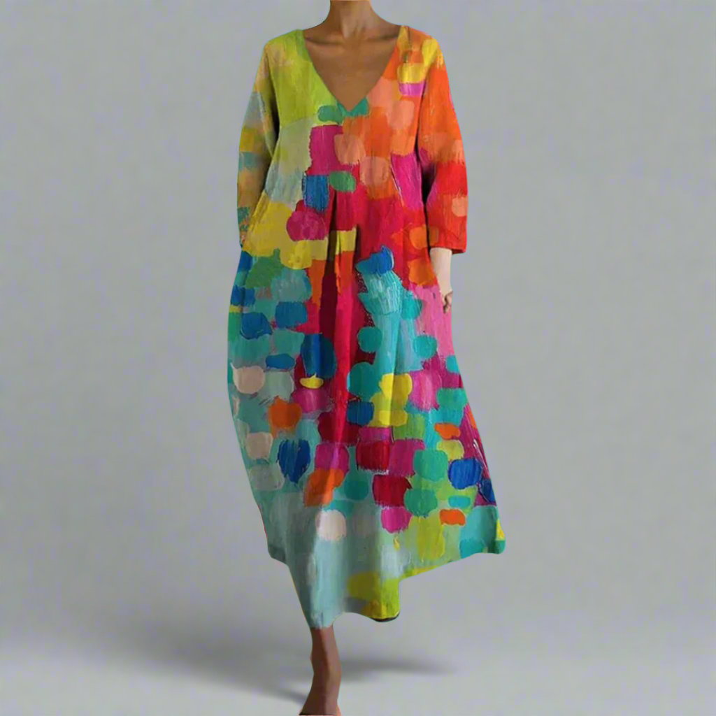 Vibrant women's artistic bohemian flowing maxi dress with abstract print, perfect for summer vacation or resort wear.