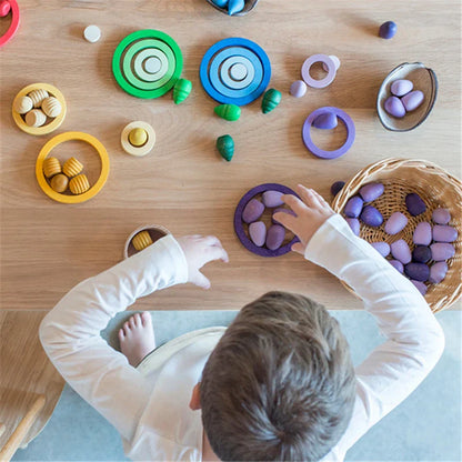 Close-up of a child's hands stacking colorful wooden rainbow blocks, an educational preschool toy