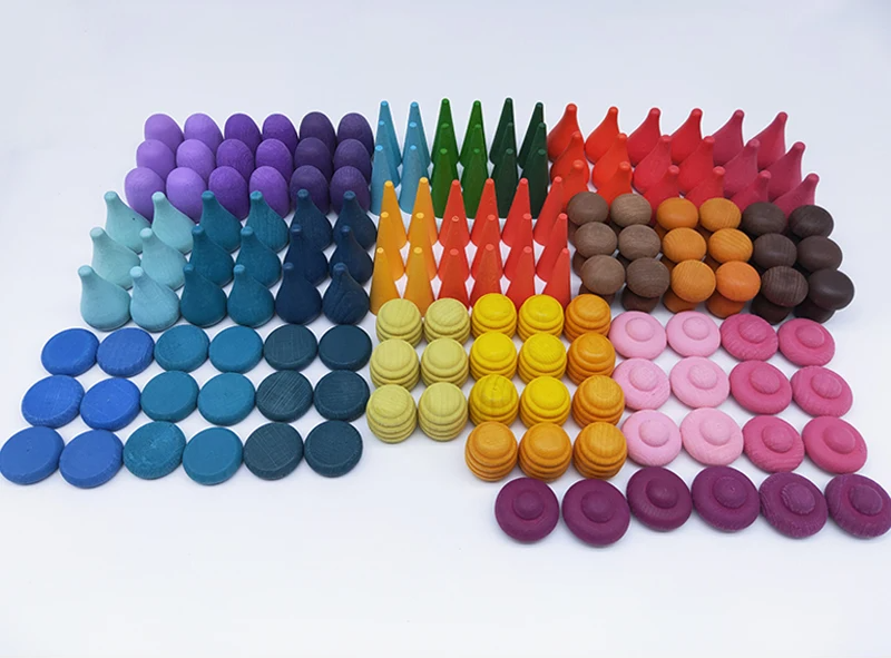 Toddler playing with a set of wooden rainbow blocks, enhancing hand-eye coordination & learning