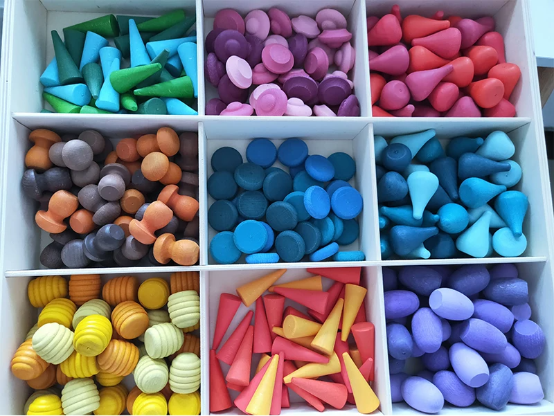 Colorful wooden blocks organized by size, a versatile and educational rainbow stacking toy for kids