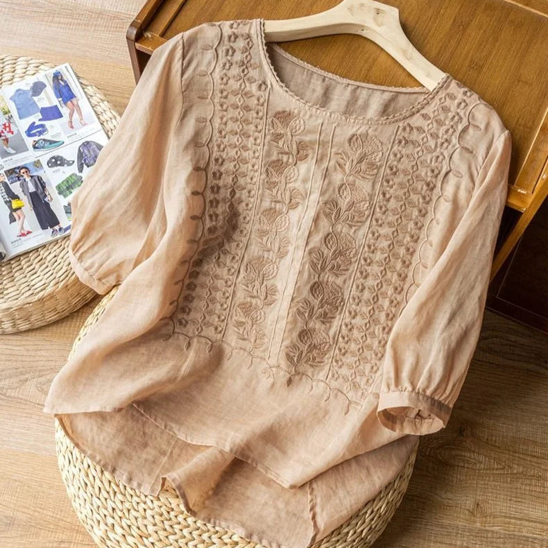 Casual chic women's blouse with vintage embroidery, relaxed fit, and sheer puff sleeves for everyday wear.