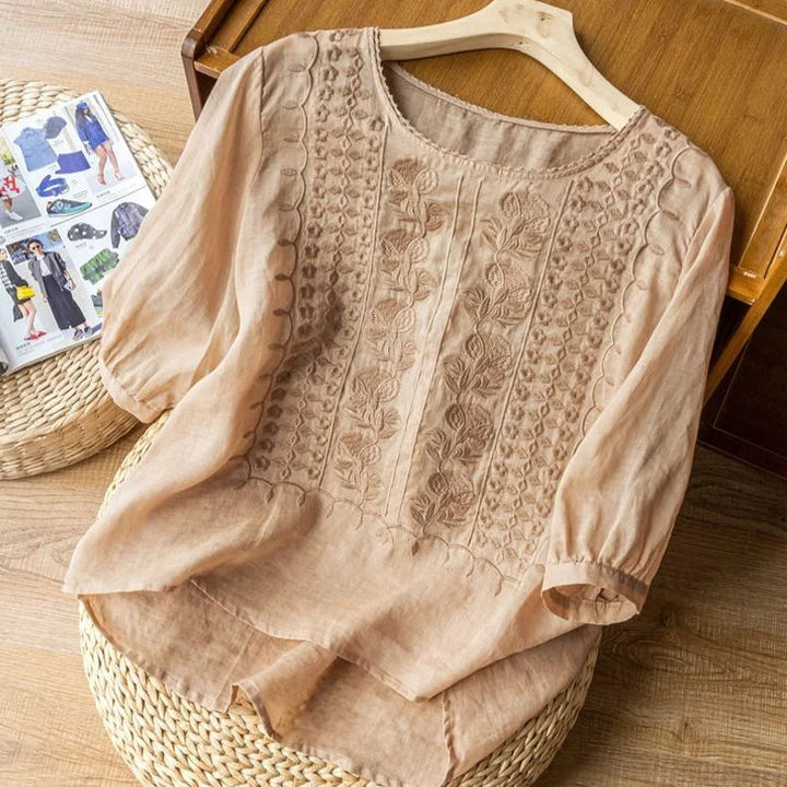 Casual chic women's blouse with vintage embroidery, relaxed fit, and sheer puff sleeves for everyday wear.