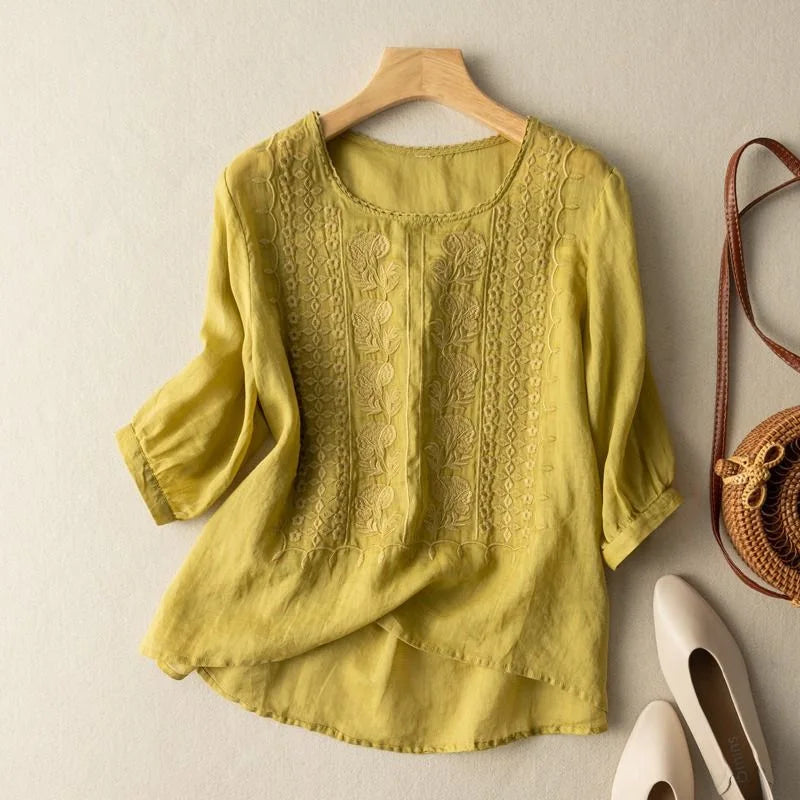 Round neck women's blouse with vintage-inspired embroidery & stylish sheer puff sleeves. Feminine & comfortable.