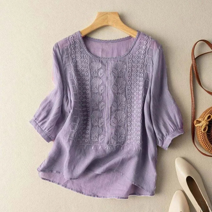 Elegant yet casual women's blouse with vintage embroidery, sheer puff sleeves, and a flattering relaxed fit.