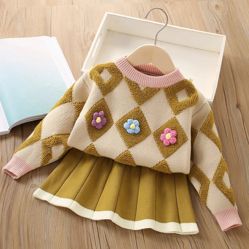 Close-up of the vintage knitted pullover texture and detail from a girls' toddler outfit set.