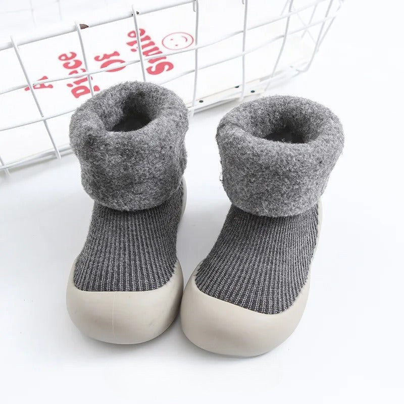 Folded pair of warm anti-slip unisex baby socks, showcasing soft textile