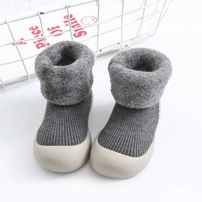 Folded pair of warm anti-slip unisex baby socks, showcasing soft textile