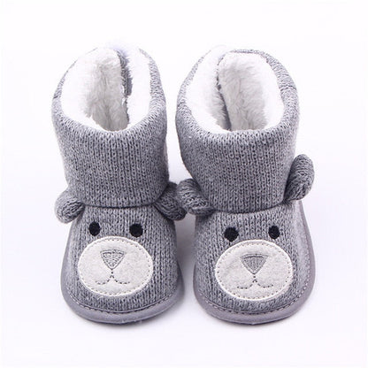 Baby in warm anti-slip winter boots, demonstrating comfort and protection for cold weather