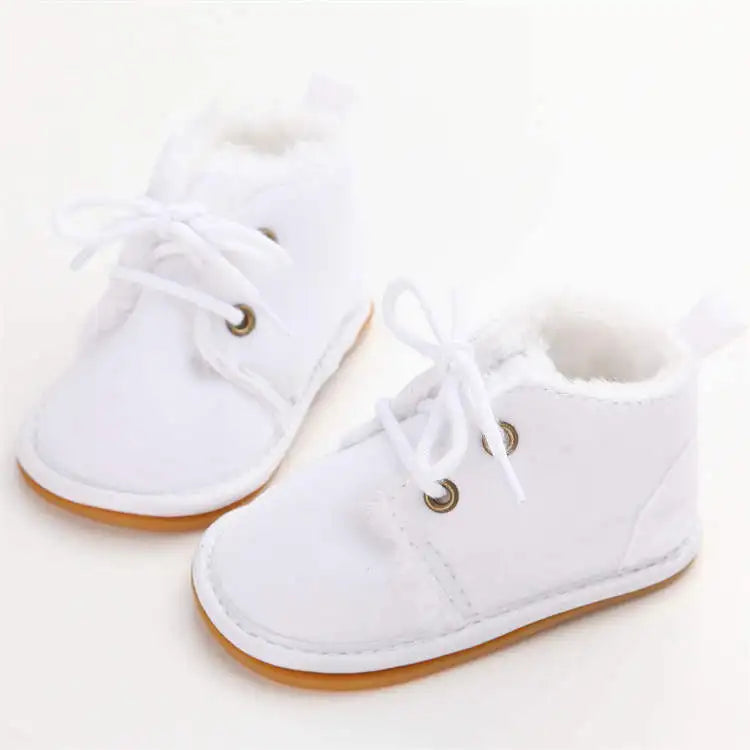 Baby footwear: warm crib shoes, perfect for keeping infant feet snug and safe indoors.