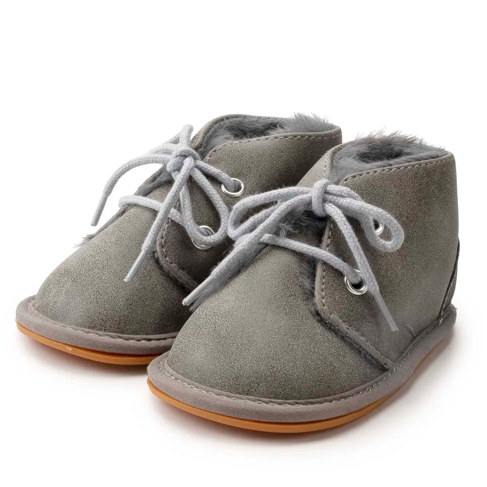 Cute infant crib shoes, perfect for keeping tiny feet warm and steady during winter.