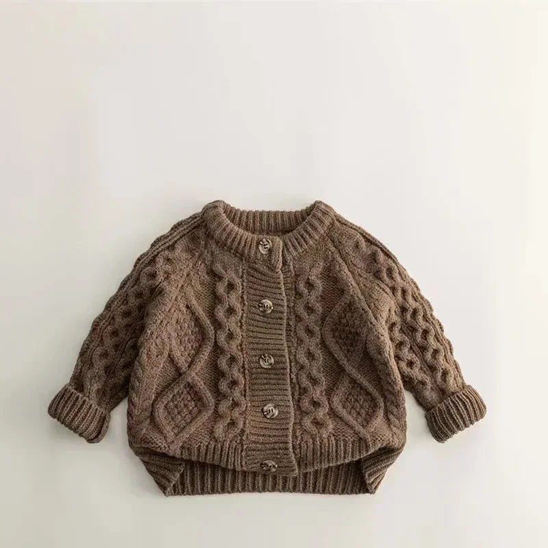 Toddler in a comfortable unisex brown knit sweater with long sleeves, playing cheerfully