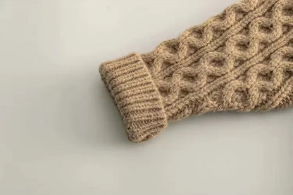 Beige kids' knitted sweater laid flat, showcasing its cozy texture and winter wear design