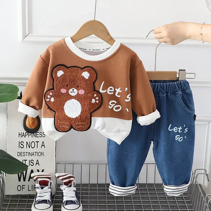 Two happy kids playing in brown and green warm winter hoodie and pants clothing sets