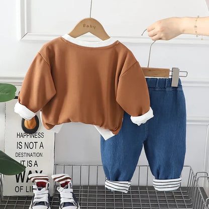 Back view of a child wearing a green warm winter hoodie and pants clothing set