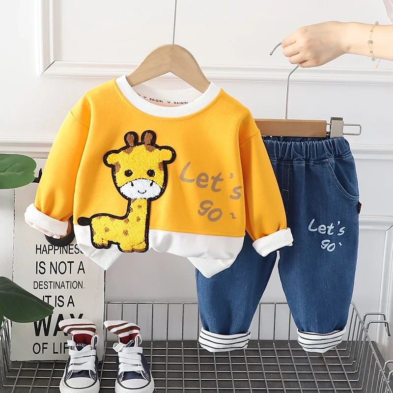 Stylish kids winter hoodie and pants set in green displayed on a hanger, ready for play
