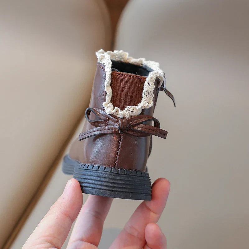 Close-up of kids leather winter boots, showing texture and sturdy construction
