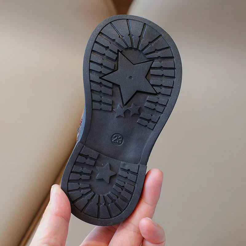 Pair of brown leather zipper boots for toddlers, ensuring easy wear and warmth