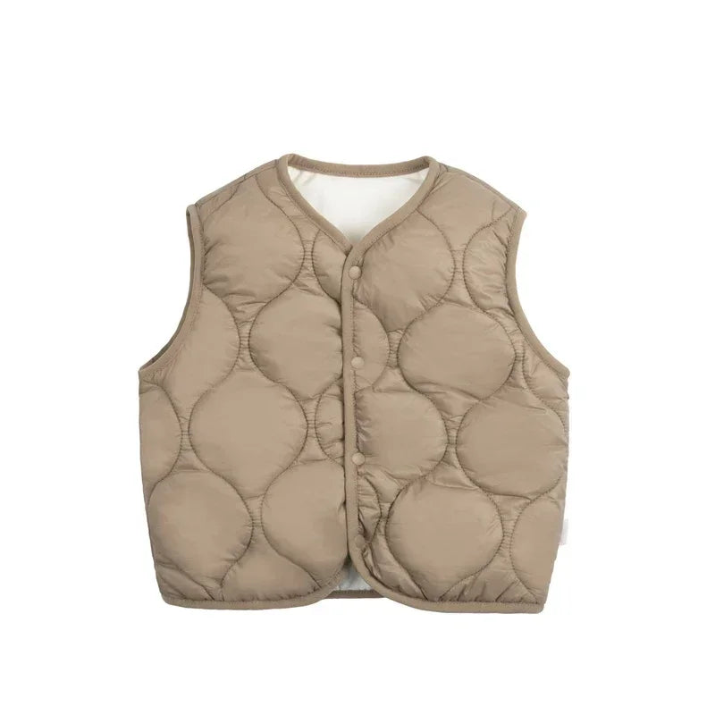 Close-up of the quilted texture on a kids' cotton puffer vest, showing stitching and material.