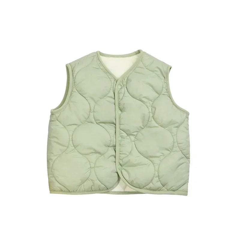 Folded warm cotton puffer vest, ready for travel, lightweight toddler outerwear, studio shot.
