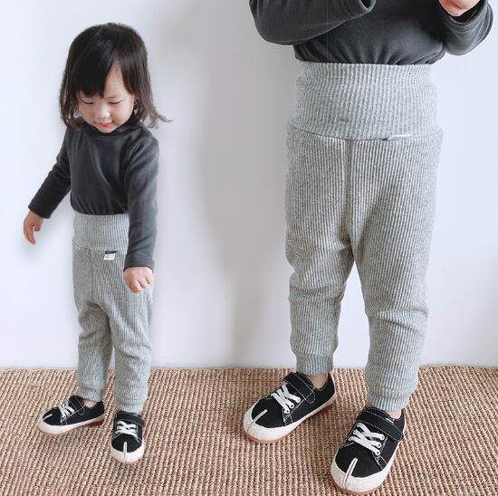 Close-up of the plush fleece lining inside ribbed cotton baby pants, emphasizing warmth.