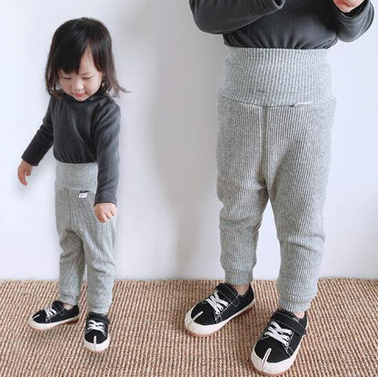 Close-up of the plush fleece lining inside ribbed cotton baby pants, emphasizing warmth.
